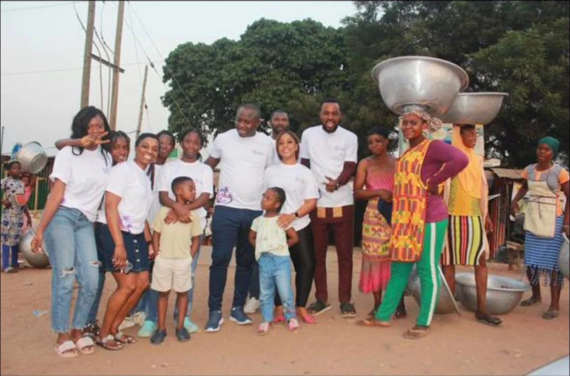 Volunteers and children gathered during community outreach