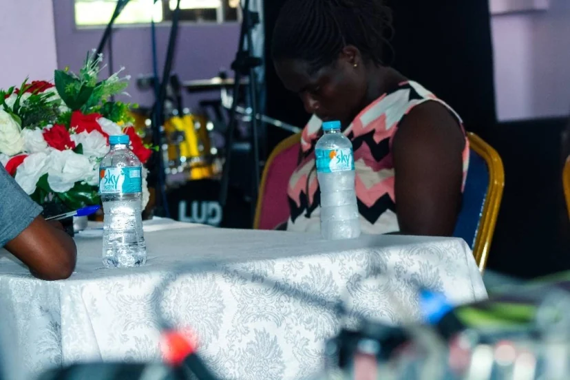 A participant seated at a Blossom Foundation event