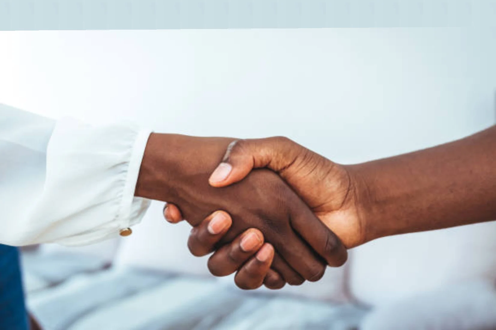 Two people shaking hands to represent partnership