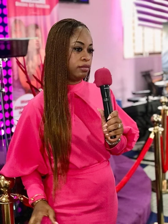 A programme facilitator speaking into a microphone